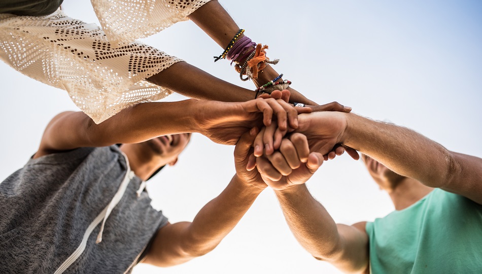 Group of friends putting hands together